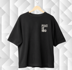 Black t-shirt with 'PEACE OF MIND' text on a geometric patterned wall