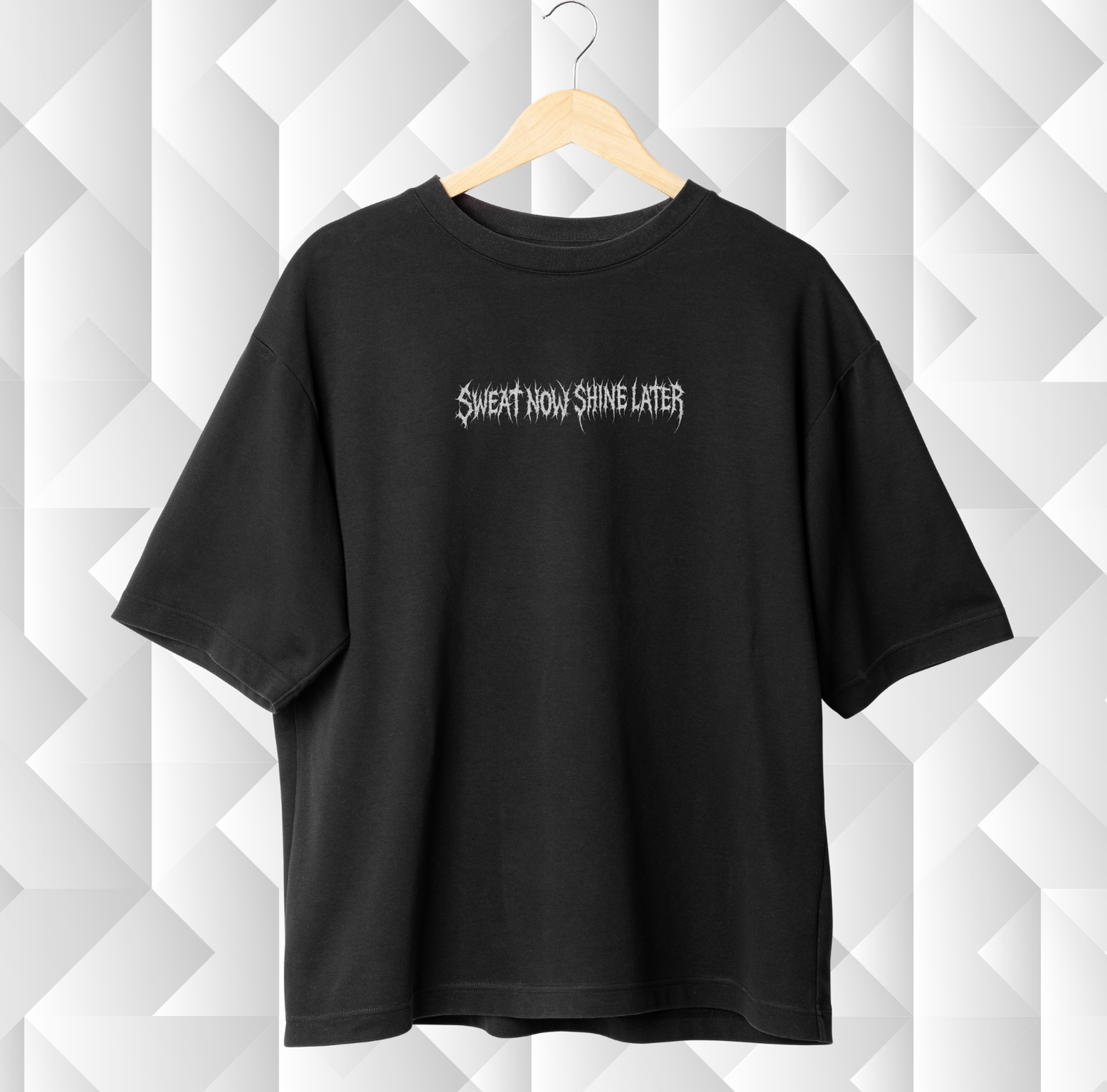 Black t-shirt with text on a white geometric patterned background