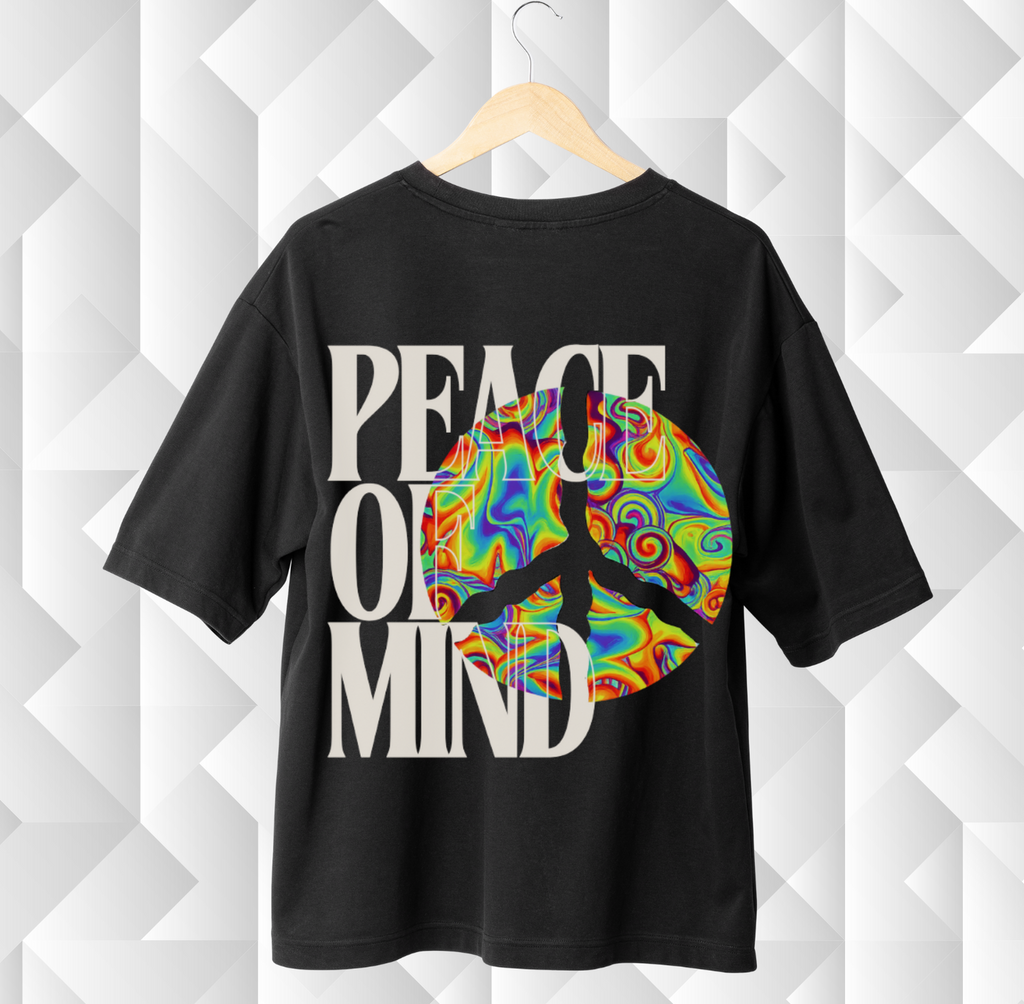 Black t-shirt with colorful peace symbol and 'Peace of Mind' text on a geometric patterned background