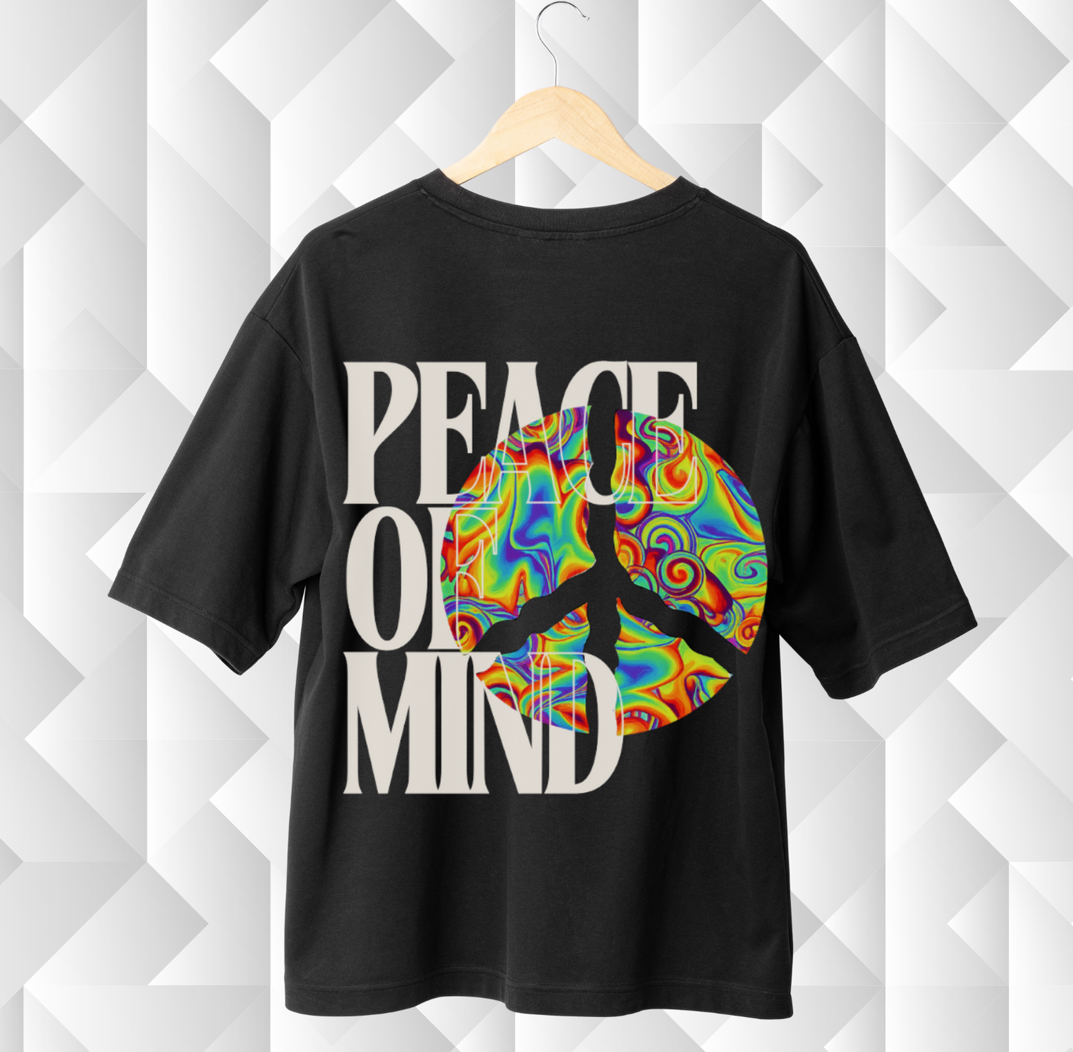 Black t-shirt with colorful peace symbol and 'Peace of Mind' text on a geometric patterned background